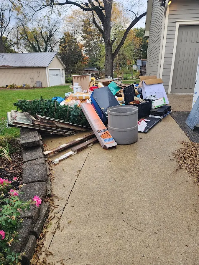 Dumpster being loaded with debris for 30 Yard Dumpster Rental in Greene